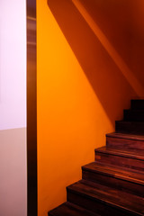 wooden staircase made from laminate wood in yellow wall room