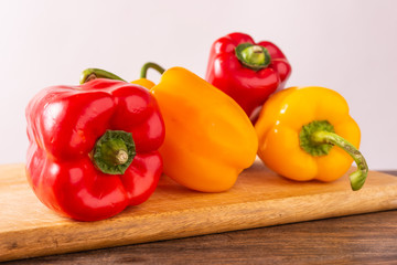 Red and yellow fresh sweet peppers on white background. Healthy ingredients, summer food