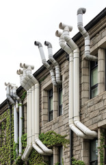 Facade of an old building with lot of plastic ventilation exhaust pipes