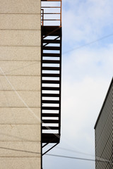 stair for fire escape with the steel railing and ladder outside of building