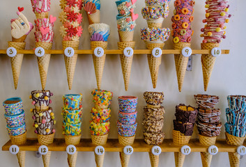 Colorful ice cream with colorful candy display on wood shelf