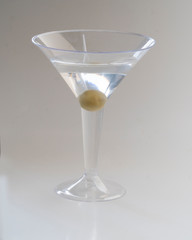 Dry martini served with an olive for a refreshing alcoholic drink for relaxation