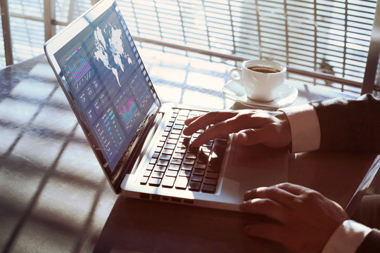 financial dashboard on computer screen, data analytics, close up of hands of businessman