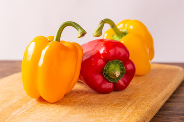 Red and yellow fresh sweet peppers on white background. Healthy ingredients, summer food