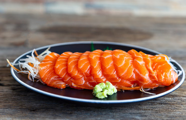 Raw salmon fillets sliced ​​in a serving dish