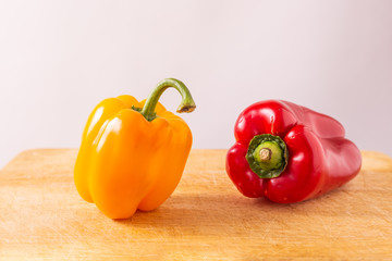 Red and yellow fresh sweet peppers on white background. Healthy ingredients, summer food