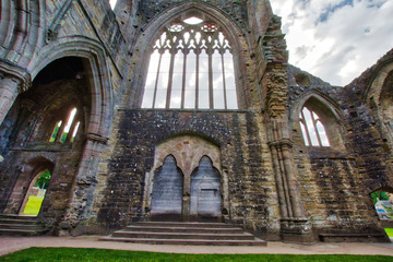 Fototapeta premium The ruins of Tintern Abbey, founded by Walter de Clare, Lord of Chepstow, on 9 May 1131. It is situated adjacent to the village of Tintern in Monmouthshire, Wales, UK.
