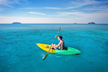 tourist paddling on kayak in tropical sea, beach travel leisure, active tourism and kayaking