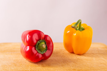 Red and yellow fresh sweet peppers on white background. Healthy ingredients, summer food