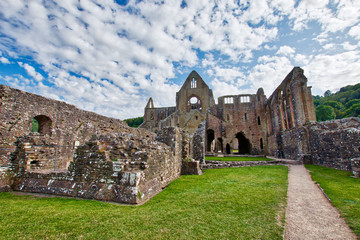 Fototapeta na wymiar The ruins of Tintern Abbey, founded by Walter de Clare, Lord of Chepstow, on 9 May 1131. It is situated adjacent to the village of Tintern in Monmouthshire, Wales, UK.