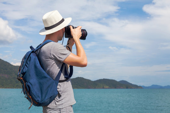 landscape travel photographer taking picture of nature seascape with dslr camera outside, ptorography trip