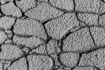 Texture of gray cracked asphalt. Abstract backdrop for design.