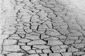 Texture of gray cracked asphalt. Abstract background for design.