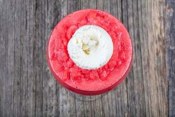 Frozen strawberry and , with ice cream on wooden floor.