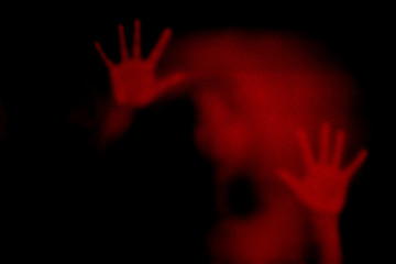 Red shadow of woman on the frosted glass representing dangerous, fear, help, haunting, horror,  scary, lockdown, infected, virus and plague - 329599443