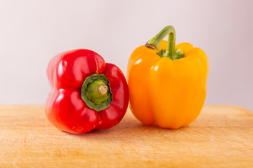 Red and yellow fresh sweet peppers on white background. Healthy ingredients, summer food