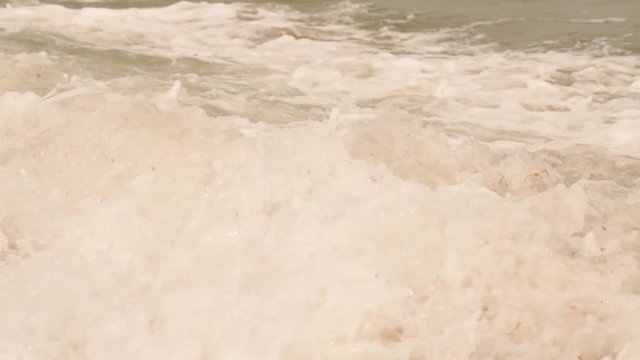 Sea water. Beautiful beach and sea. Colorful Ocean Wave. Golden sand beach at the afternoon sun, sea breeze in the air, long flat waves, side view of the beach. 