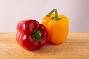 Red and yellow fresh sweet peppers on white background. Healthy ingredients, summer food