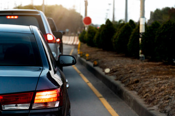 Luxury of gray car stop on the asphalt junction by traffic light control in across. Traveling in the provinces during the bright period. Open light brake.