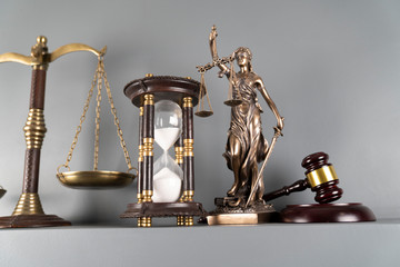 Lawyers office concept. Law symbols composition – gavel, scale and Themis statue on off-white...