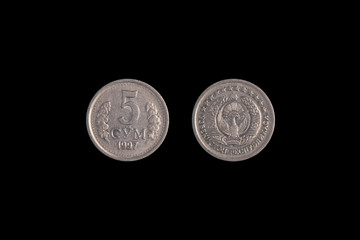 5 Uzbek som coin 1997 on a black background. close-up on both sides
