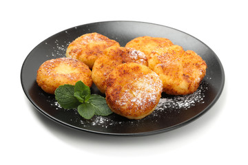 Plate with cheese pancakes and mint isolated on white background