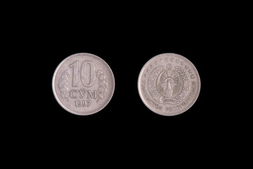 10 Uzbek som coin on a black background. close-up on both sides
