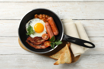Delicious breakfast or lunch with fried eggs on wooden background, top view
