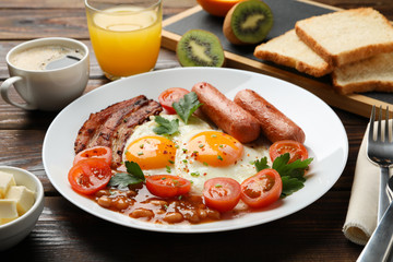 Fototapeta na wymiar Delicious breakfast or lunch with fried eggs on wooden background, close up