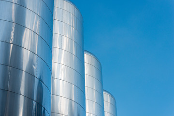 Beer fermentation tanks with blue background.