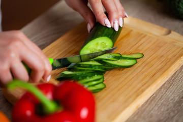Young beautiful girl preparing wholesome diet salad