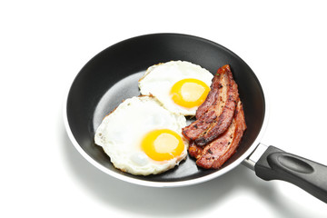 Pan with fried eggs and bacon isolated on white background
