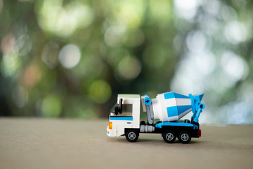 Blue cement mixer truck toy. Business commercial concept.