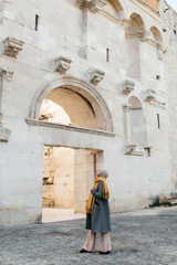 Fototapeta na wymiar portrait of young European Muslim women with hijab exploring old city of Split as tourist. Diocletian's palace. 