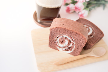 chocolate jam roll and a cup of black coffee.
