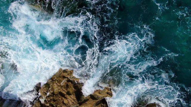 Wild Ocean water from above - Waves hitting the rocks - aerial photography