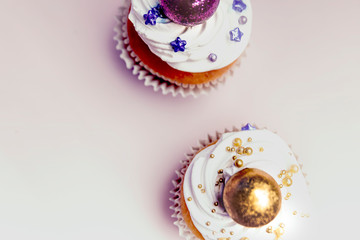 Sweet, colorful cupcakes decorated with sugar paste and cream. Concept of art paty. Flat lay, top veiw