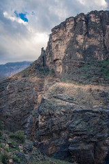 Slope of a mountain with a road running through Jebel Shams, Oman