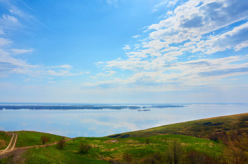 Mountain sea shore in the fall against the blue sky with clouds.