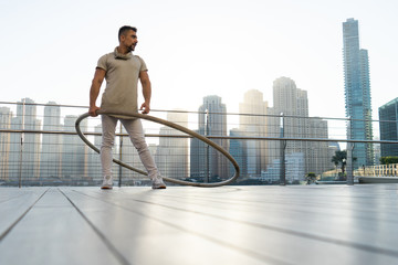 Cyr Wheel artist with cityscape background of Dubai during sunset