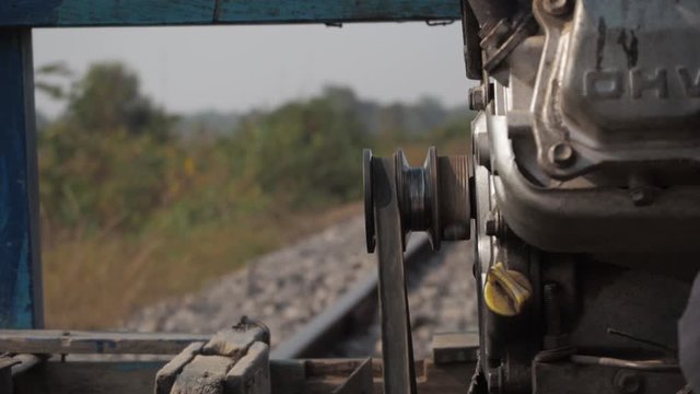 Engine drive belt spinning on bamboo train, close up