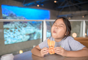 Cute asian girl enjoy to eat bread at .convenience store,