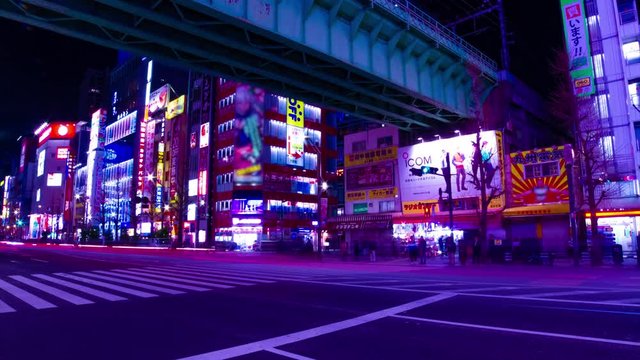 A night timelapse of the neon street at the downtown in Akihabara Tokyo wide shot tilt