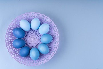 Easter eggs are blue and light blue in a beautiful purple. basket. spring composition, flatlay