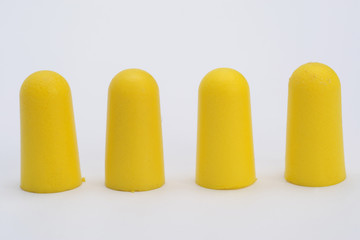 Foam ear plugs isolated on white background. Yellow ear plugs isolated