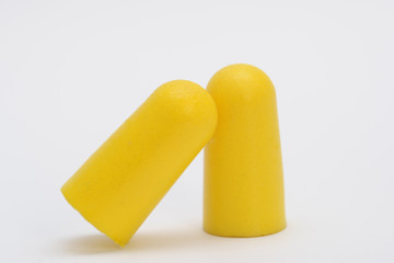 Foam ear plugs isolated on white background. Yellow ear plugs isolated