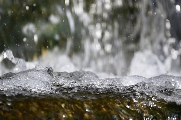 Obraz na płótnie Canvas Frozen water drops of forest waterfall 