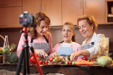 Multi-generational all female family of influencers creating vlog about healthy eating habits and raw vegan food preparation