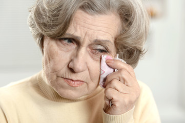 Portrait of a stressed senior woman crying