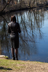 Woman legs in pantyhose, unisex clothes, girl  look to the lake